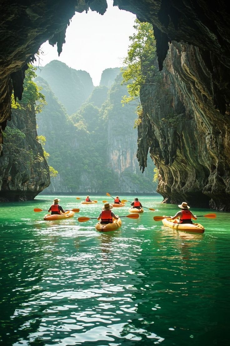 Kayakers paddling through limestone sea caves