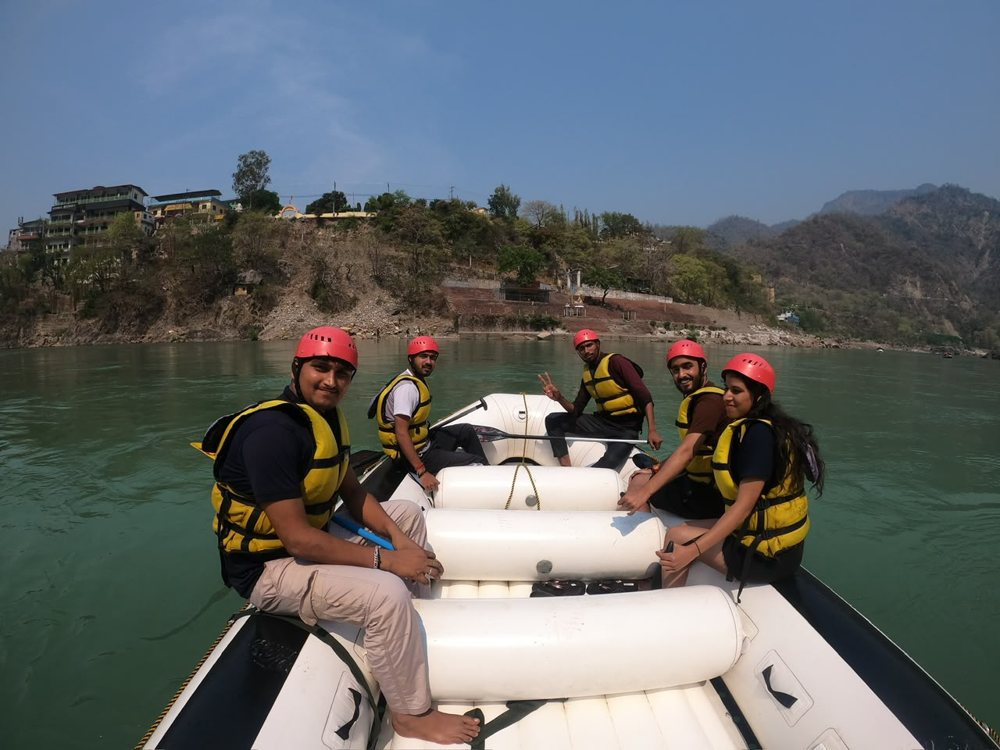 Group in helmets and life jackets on a raft on the Ganga, Rishikesh